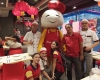 group of hap chan staff smiling with hap chan mascot